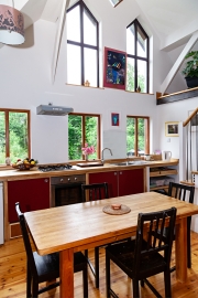 Windowed kitchen open to the living area  of County Clare Ecohouse, Ireland