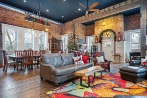 Brick walls and tall ceiling images inside converted schoolhouse