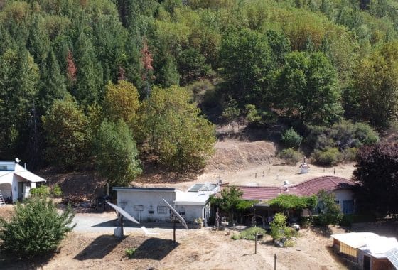 Aerial view of the earth-sheltered off grid home and acreage.
