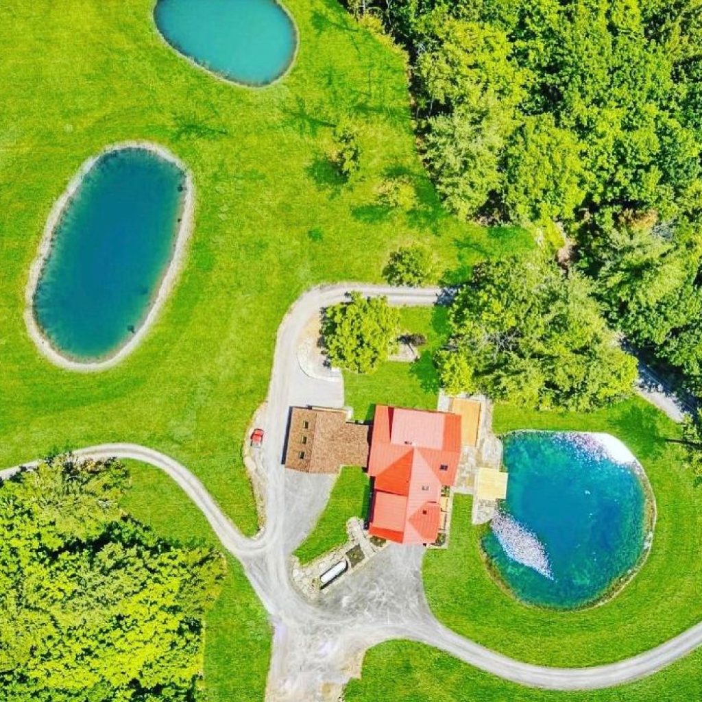 Aerial View of 165 Vaughn HIll Rd, Middleburgh, NY overlooking swimming pond of this NY Mountain Retreat.