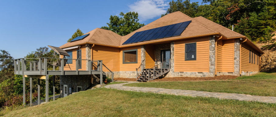 Exterior of off-grid home with solar panels.