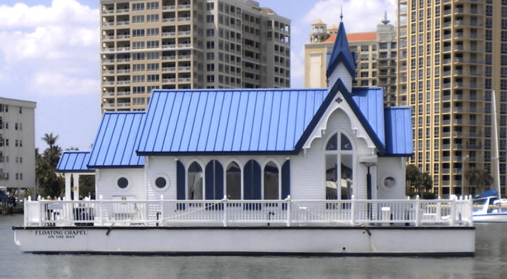 Photo of the former floating chapel, now Archangel on her way to new location.